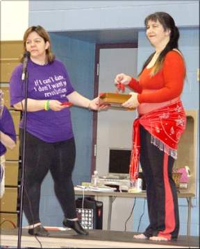 In this picture, Miyah offers Aziza Sa’id the box of name tickets to draw one.