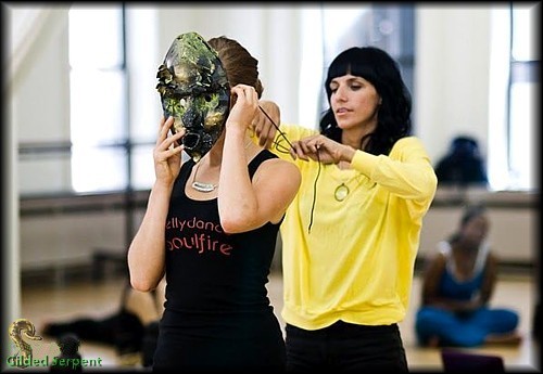 Co-teacher Dixie Rose of P.U.R.E. puts a mask on conference attendee Karolina