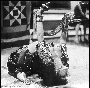 old pic of Sharifa doing backbend with a fat snake over her head